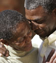 Elderly couple embrace